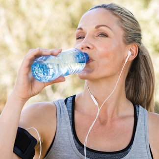 Žena pijící vodu z lahve